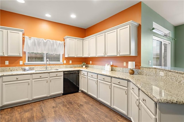 kitchen with dishwasher, white cabinetry, dark hardwood / wood-style floors, and sink