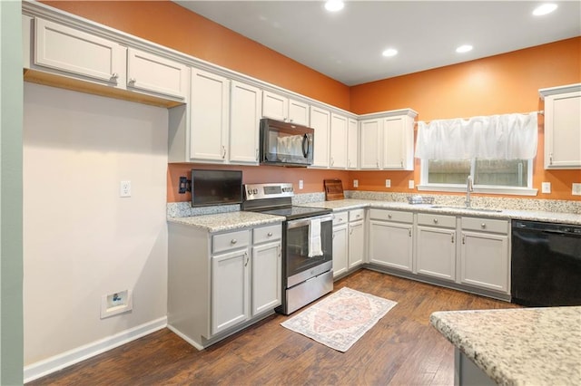 kitchen with black appliances, sink, dark wood-type flooring, and light stone countertops