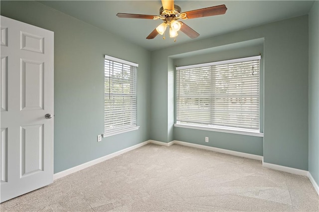 unfurnished room with ceiling fan and light carpet