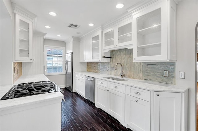 kitchen featuring light stone counters, sink, white cabinetry, stainless steel appliances, and dark hardwood / wood-style floors