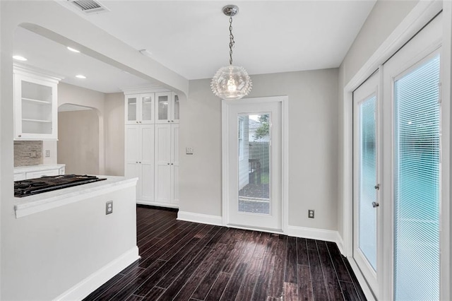 kitchen featuring hanging light fixtures, tasteful backsplash, white cabinets, gas cooktop, and dark hardwood / wood-style floors