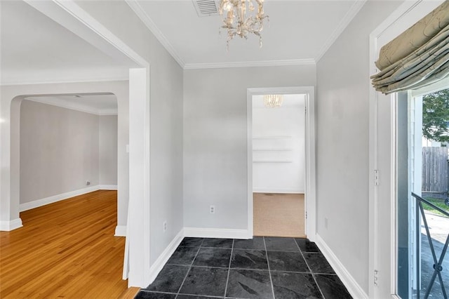 entrance foyer with crown molding, dark hardwood / wood-style flooring, and a chandelier