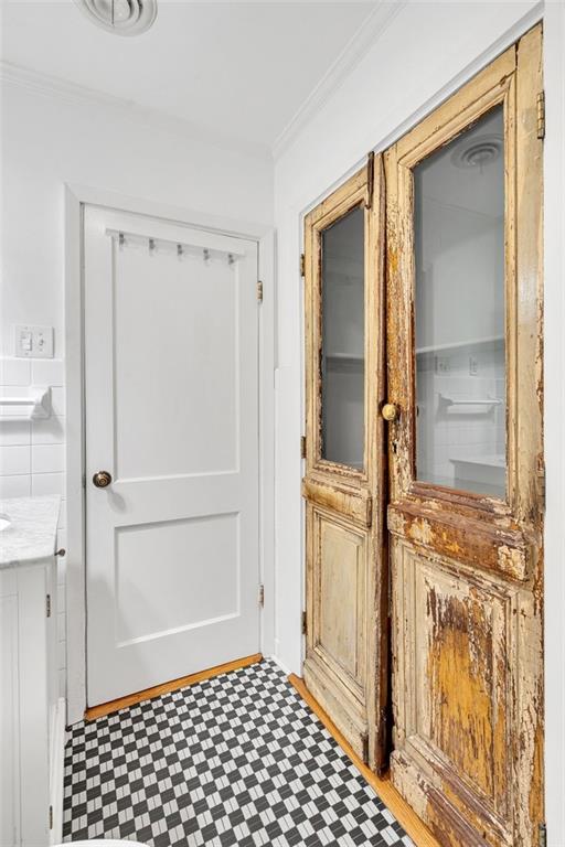 doorway to outside featuring crown molding