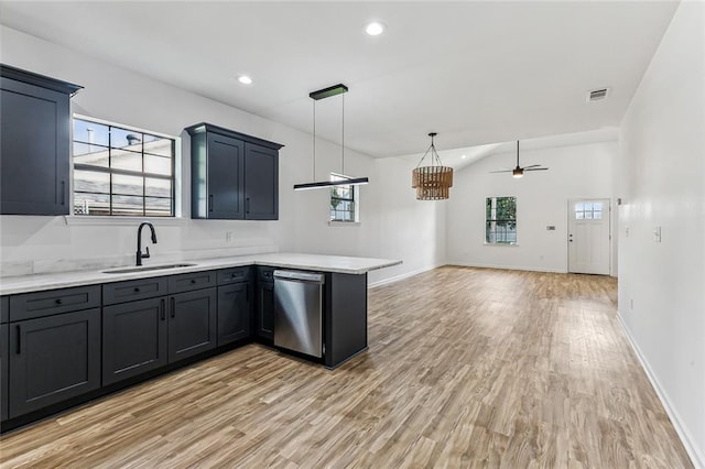 kitchen featuring dishwasher, ceiling fan with notable chandelier, plenty of natural light, and kitchen peninsula