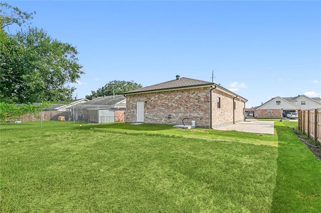 rear view of house with a yard and a patio