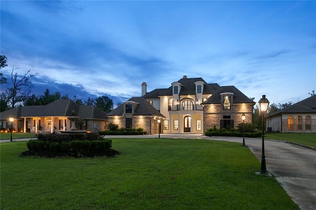 french country home with a yard