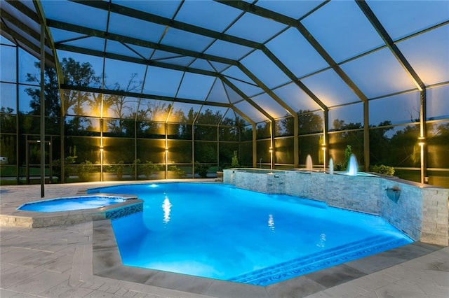 view of pool featuring an in ground hot tub, a lanai, and pool water feature