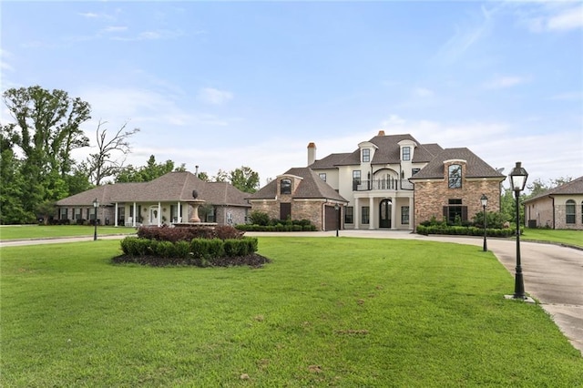 french country inspired facade with a front lawn