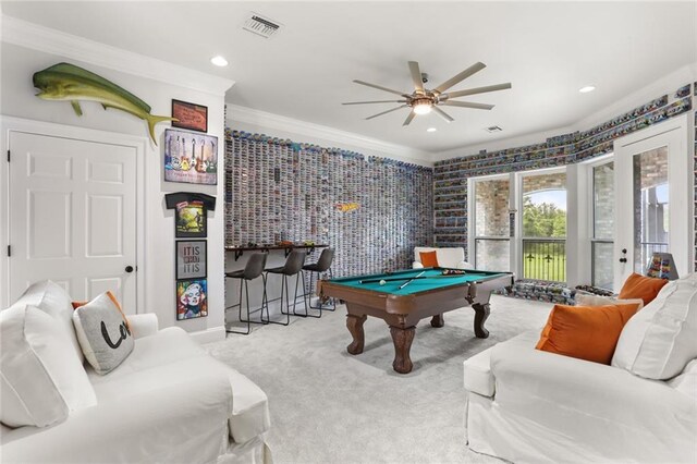 rec room with pool table, ornamental molding, ceiling fan, and light colored carpet