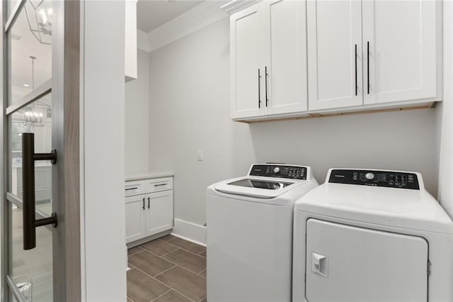 laundry room with cabinets, crown molding, and washer and dryer