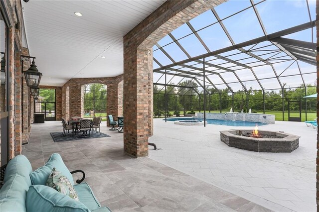 exterior space featuring an in ground hot tub, a lanai, and a patio area