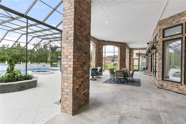 view of patio with glass enclosure and a pool with hot tub