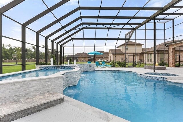 view of pool featuring pool water feature, a lanai, and a patio area