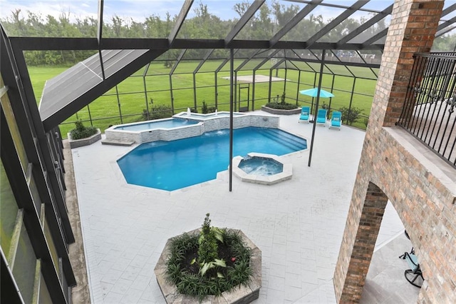 view of swimming pool with a patio, glass enclosure, and an in ground hot tub