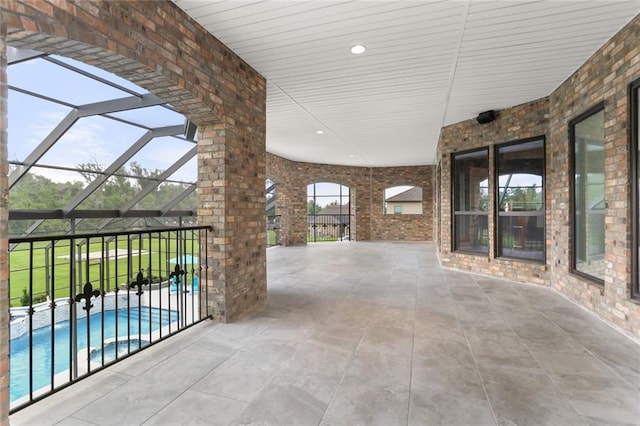 view of patio featuring a lanai