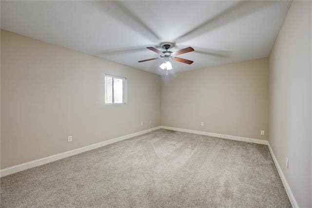 carpeted empty room featuring ceiling fan