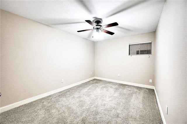 carpeted empty room with ceiling fan