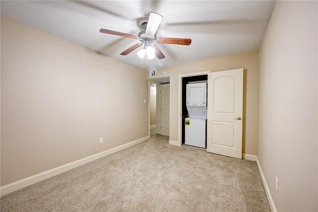 unfurnished bedroom featuring ceiling fan and light colored carpet