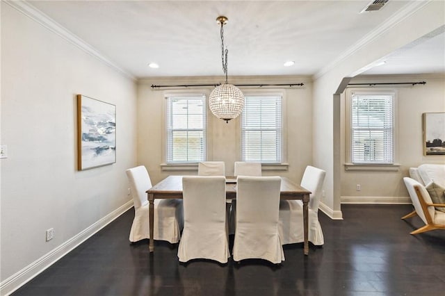 dining room featuring ornamental molding, dark wood-type flooring, and a chandelier