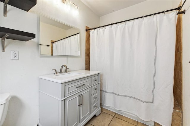 bathroom featuring tile patterned floors, vanity, and toilet