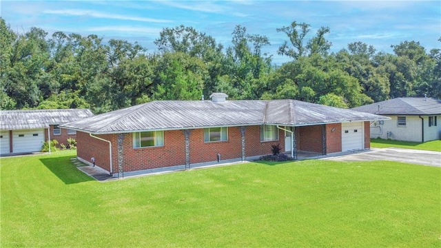 single story home featuring a garage and a front lawn