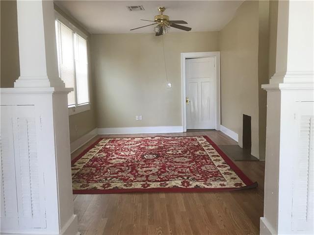 entryway featuring decorative columns, dark hardwood / wood-style flooring, and ceiling fan