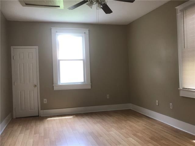 spare room with light hardwood / wood-style flooring and ceiling fan