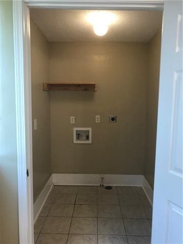 laundry area with tile patterned flooring, hookup for an electric dryer, and washer hookup