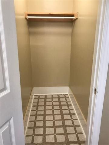 walk in closet with tile patterned flooring