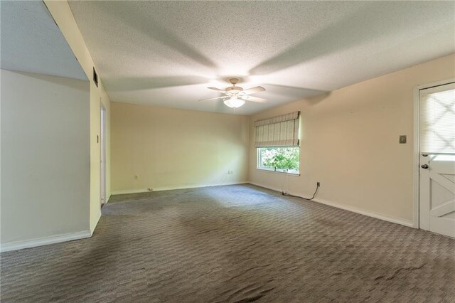 carpeted spare room featuring ceiling fan and a textured ceiling