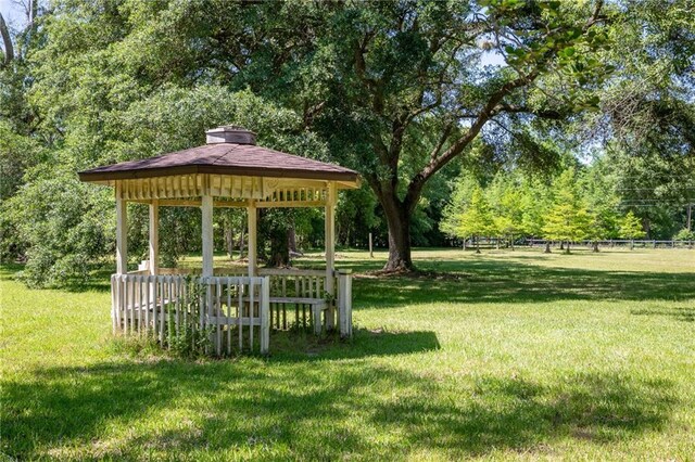 view of home's community with a gazebo and a yard