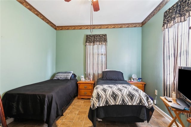 bedroom with baseboards, ornamental molding, and a ceiling fan