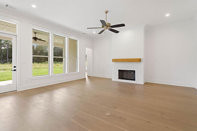 unfurnished living room with hardwood / wood-style flooring, a fireplace, plenty of natural light, and ornamental molding