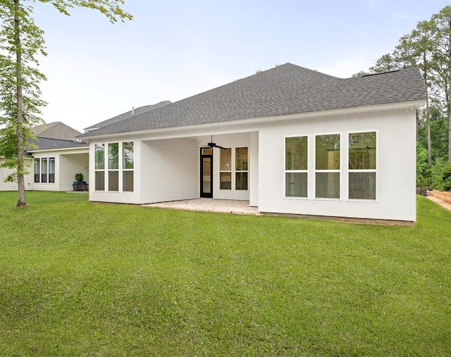 rear view of house featuring a lawn