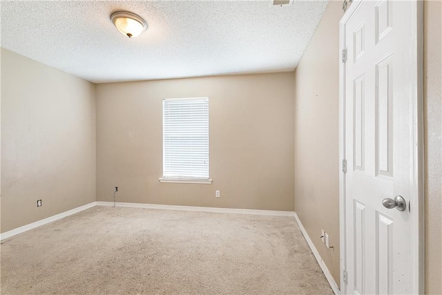 carpeted spare room featuring a textured ceiling