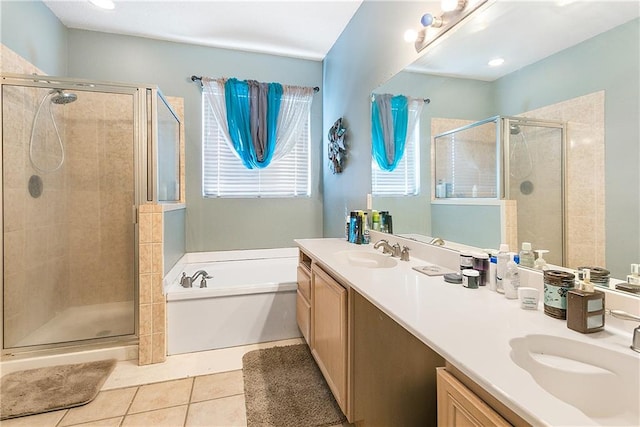 bathroom featuring tile patterned flooring, vanity, and plus walk in shower