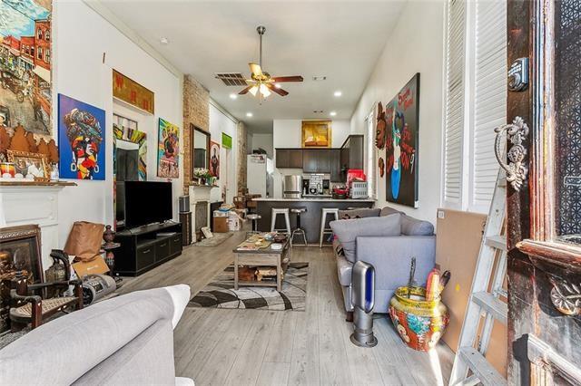 living room with ceiling fan and light hardwood / wood-style floors