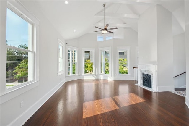 unfurnished living room featuring high vaulted ceiling, wood-type flooring, ceiling fan, and a healthy amount of sunlight