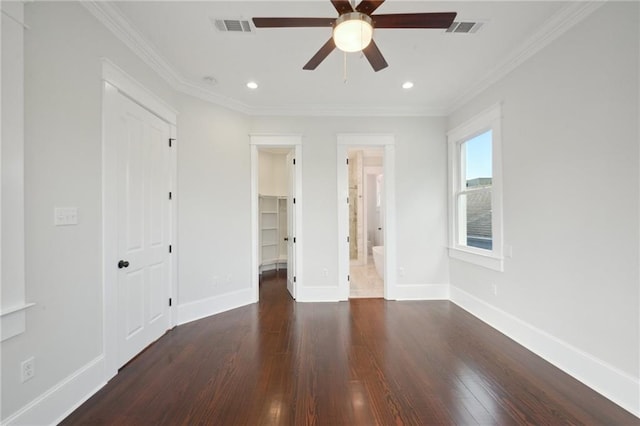 unfurnished bedroom with a closet, dark wood-type flooring, ensuite bathroom, crown molding, and ceiling fan