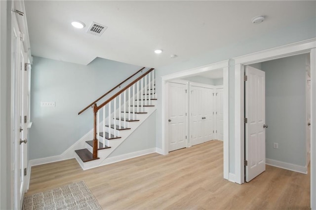 kitchen featuring appliances with stainless steel finishes, light wood-type flooring, ceiling fan, and white cabinets