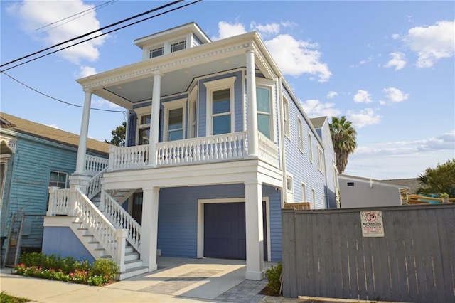 2412 N Rampart St, New Orleans, LA 70117 - view of front of property featuring an attached garage, a porch, fence, stairway, and driveway