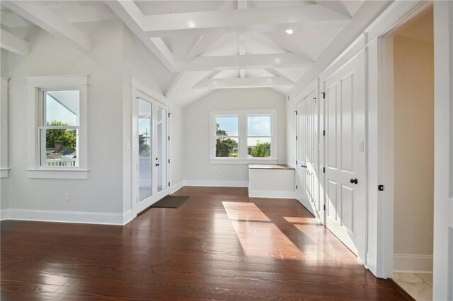 interior space featuring lofted ceiling with beams and dark wood-type flooring