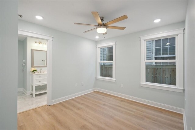 unfurnished bedroom featuring light wood-type flooring and ceiling fan