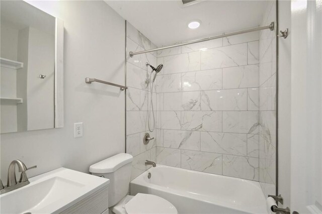 full bathroom with tiled shower / bath combo, vanity, and toilet