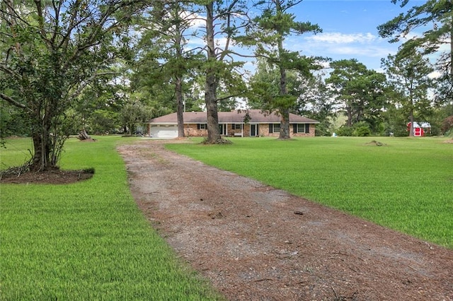 single story home with a garage and a front lawn