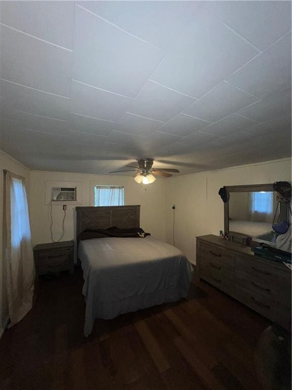 bedroom featuring an AC wall unit, ceiling fan, and dark wood-type flooring