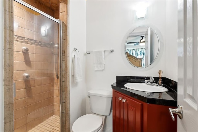 bathroom with vanity, toilet, and a shower with shower door