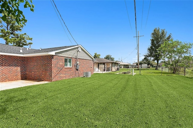 view of yard with central air condition unit and a patio area