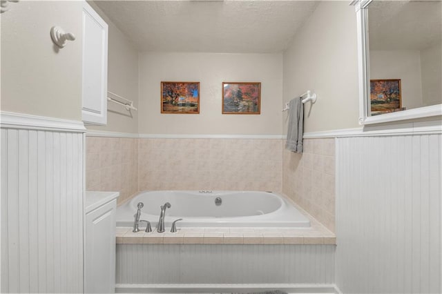 bathroom featuring a textured ceiling and a bathtub