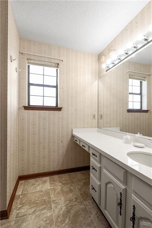 bathroom with vanity and a textured ceiling